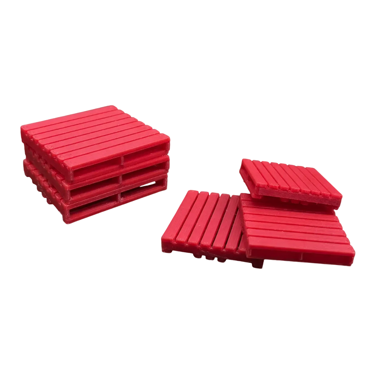 Three red plastic scale model pallets shown on a light gray background, framed by a black border with yellow corner markers and text reading 'SCALE MODEL PALLETS' and 'Pallets'.